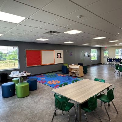 Bright colored school furniture and an interactive space are available for children at the Foundations Community Childcare Center