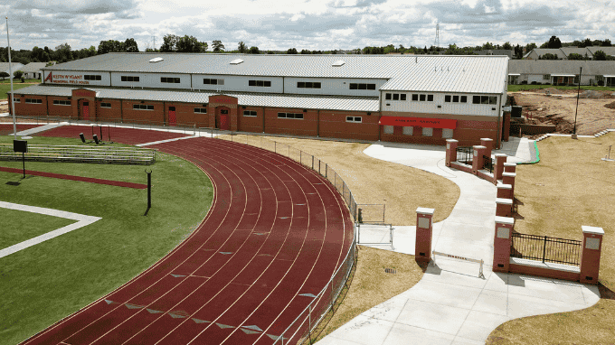 The fieldhouse at Ashland City Schools is situated just south of the 8-lane track at the high school football stadium. A concrete walkway connects the fieldhouse to the stadium entrance.